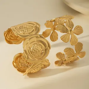 Two-piece gold floral open cuff bracelets featuring textured rose and hollow petal designs