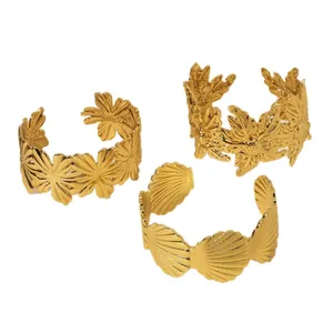 Three-piece gold hammered cuff bracelet set with sunflower, leaf, and shell embossed designs