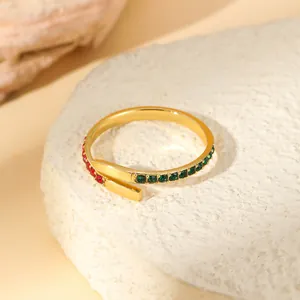 Detail of adjustable gold-plated ring with inlaid red and green zircon gemstones