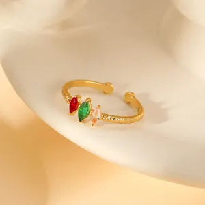 Macro view of adjustable gold ring with three colored marquise-cut stones and texture