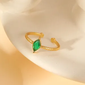 Detail of green marquise gemstone on hammered gold-plated adjustable open ring