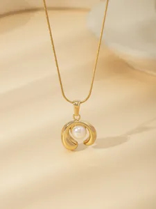 Detailed macro view of 18k gold-plated pendant with a white pearl on a snake chain