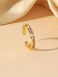 Detailed close-up of a gold-plated C-shaped ear cuff set with pink cubic zirconia stones