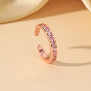 Rose gold ear cuff with pink cubic zirconia pavé setting in a minimalist luxury design