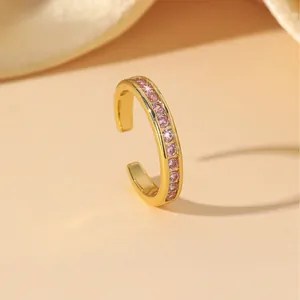 Minimalist gold ring with pink zircon inlay in a sleek C-shaped open design