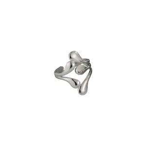 Macro view of silver irregular liquid metal ring featuring a hollow water drop design