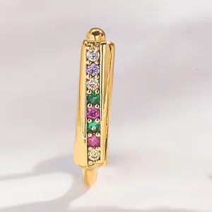 Macro view of gold-plated nose cuff with vibrant multi-color cubic zirconia inlay