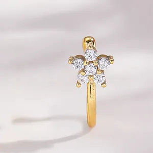 Macro view of a gold star-shaped faux nose ring with sparkling cubic zirconia inlay