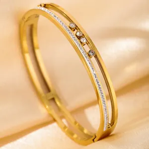 Luxury gold bangle with three sliding stones and shimmering zircon inlay on silk