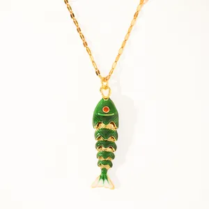 Close-up of 18k gold plated koi fish necklace with green enamel and flexible joints