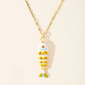 Macro detail of 18k gold plated koi fish pendant with vibrant enamel and orange crystal eye