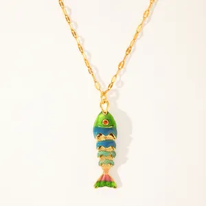 Detailed macro view of an 18k gold plated koi fish pendant with colorful enamel drip glaze