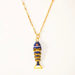 Detail of 18k gold plated necklace with blue enamel koi fish pendant and red crystal eye