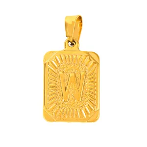 Detail of gold rectangular pendant with embossed letter W and textured edges