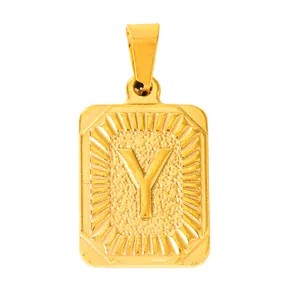 Detail of gold rectangular pendant with embossed letter Y and textured sunburst finish