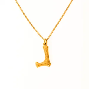 Detail of 18k gold plated letter L pendant with unique wood-like texture on link chain