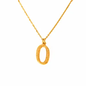 Detailed macro view of 18k gold plated letter O pendant with textured hammer finish surface
