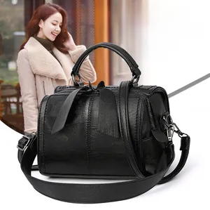 Detail of black Boston bag showing lychee pattern leather and grey metal zipper