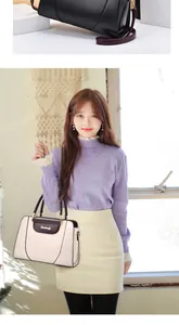 Detalle del bolso tote de cuero estructurado con asa elegante y logotipo metálico frontal
