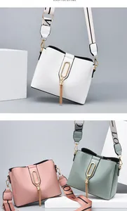 Detailed view of fashion crossbody bags with wide straps and gold tassel pendants