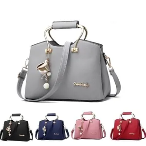 Grey textured leather tote bag with metal handles, crossbody strap and color options
