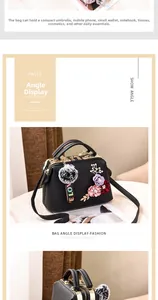 Detailed view of black litchi leather handbag with floral decor and its internal capacity