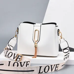 White bucket handbag with gold hardware and LOVE letter woven crossbody shoulder strap