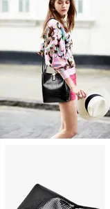 Polished black crocodile pattern bucket bag with golden hardware and adjustable strap
