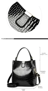 Detail view of glossy black crocodile pattern bucket bag with dimensions and gold buckle