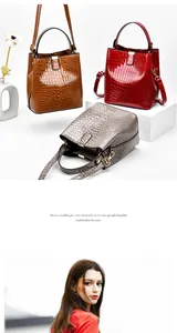 Detail of glossy crocodile pattern bucket bags in brown, dark red and grey colors