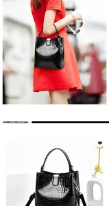 Close-up of black crocodile pattern bucket bag with high-gloss finish and metal clasp