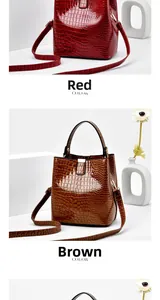 Detail view of glossy faux leather bucket bags with crocodile texture in red and yellow