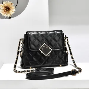 Elegant black quilted chain bag with gold geometric lock and leather strap detail