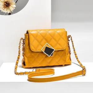 Quilted crossbody chain bag in bright yellow faux leather with geometric buckle decor