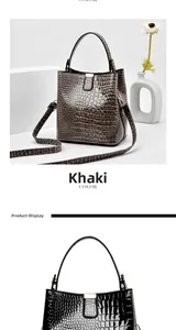 Macro detail of khaki crocodile embossed texture and metallic gold hardware on bucket bag
