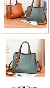 Detail view of stylish PU leather handbags in orange and grey with golden ring accents