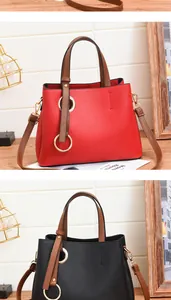 Detailed view of fashionable PU leather handbags in red and black with gold ring accents