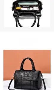 Détails d'un sac à main noir motif crocodile montrant l'intérieur compartimenté et zippé