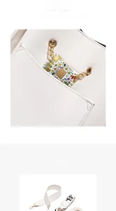 Close-up of white bucket bag featuring a functional back pocket and wide shoulder strap