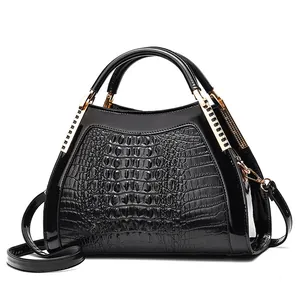 Classic black crocodile pattern handbag with gold hardware and detachable shoulder strap
