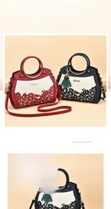 Detail of floral laser-cut patterns on faux leather tote bag with metal handles