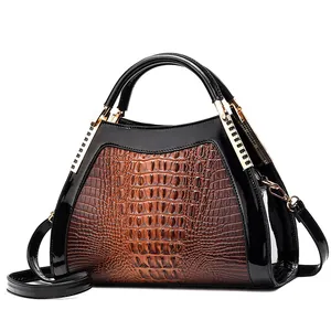 Classic brown crocodile texture handbag with black patent leather accents and gold hardware