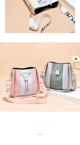 Close-up of stylish women's bucket bags featuring golden chain tassels and wide straps.
