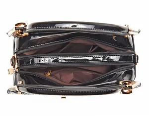 Detail of classic black tote with double zipper compartments and brown fabric lining