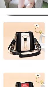 Detailed view of a black and white bucket bag featuring a stylish patterned wide strap