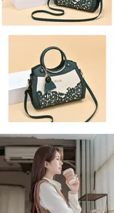 Detail of hollow floral pattern and pearl accents on dark green leather handbag
