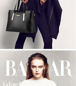 Dettaglio borsa tote in pelle intrecciata nera con finiture dorate e logo del marchio