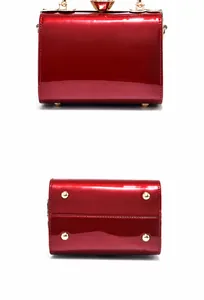 Detail view of the red patent leather bag showing the back and gold base studs