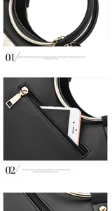 Detail of gold metal ring handles and rear zipper pocket on a black PU leather tote bag