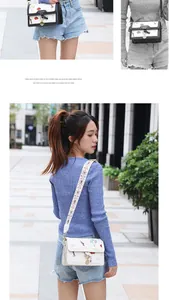 Detail of the ethnic embroidered wide shoulder strap and metal ring buckle on the crossbody bag